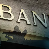 A cropped photograph of a sign that says bank, only part of the letters are showing. 